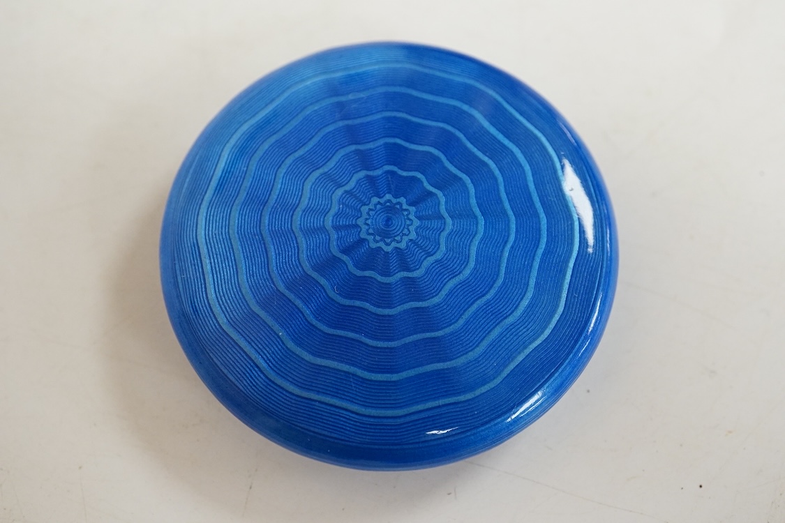 A George V silver and enamelled circular compact, the cover depicting a lady and gentleman, import marked for P.H. Vogel & Co, London, 1924, diameter 51mm.